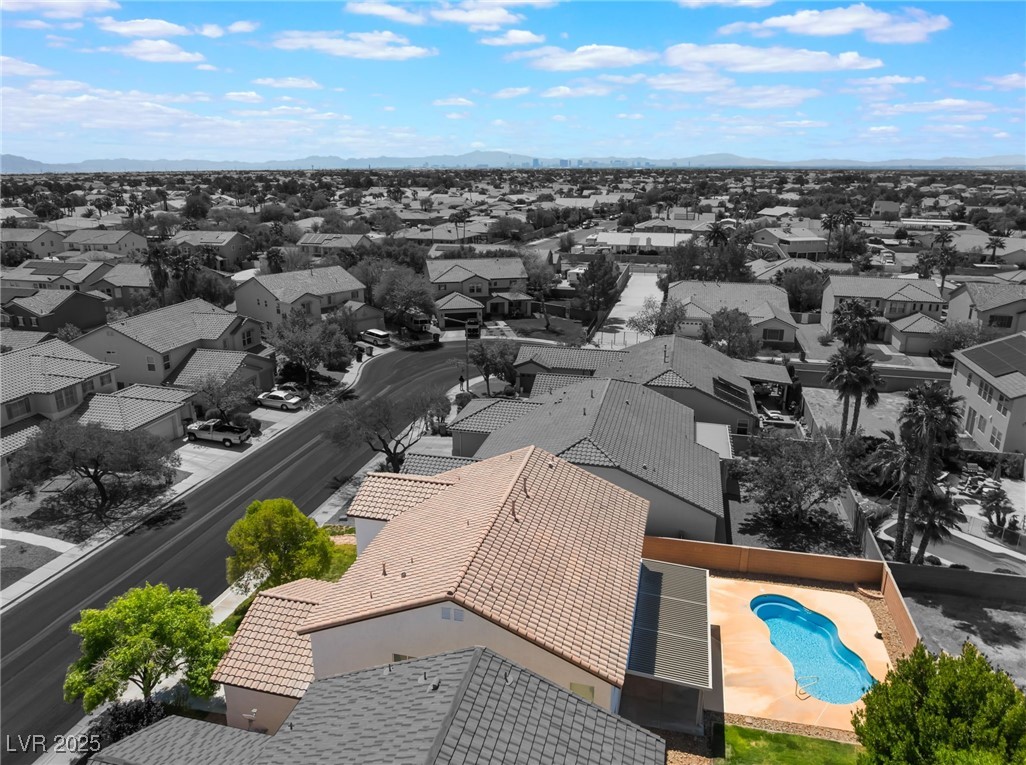 7857 Midnight Ride Street Las Vegas, NV 89131 - Photo 47 of 53 Aerial view of residential area featuring a pool and a mountain backdrop