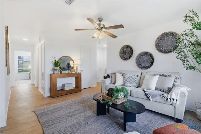 a living room with fireplace furniture and decor