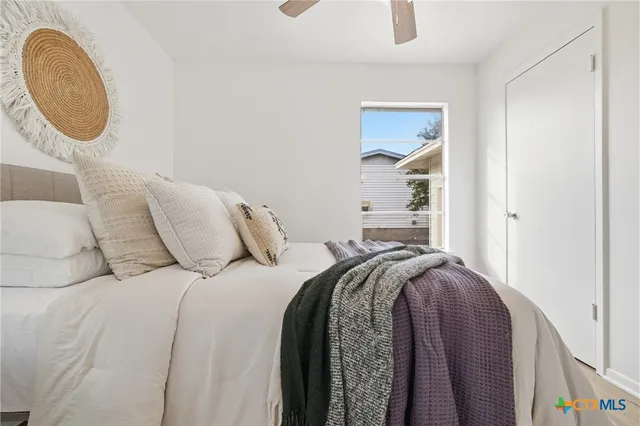 a bed sitting in a bedroom next to a window