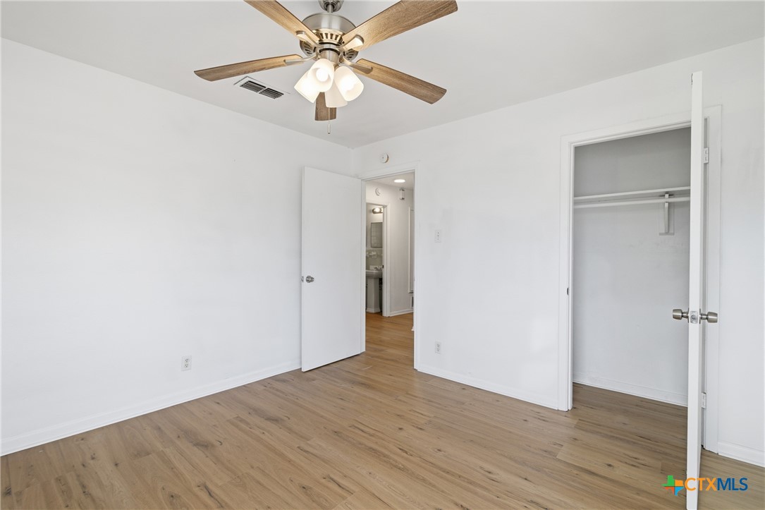 958 Fannin Loop Temple, TX 76501 - Photo 15 of 30 an empty room with wooden floor fan and windows