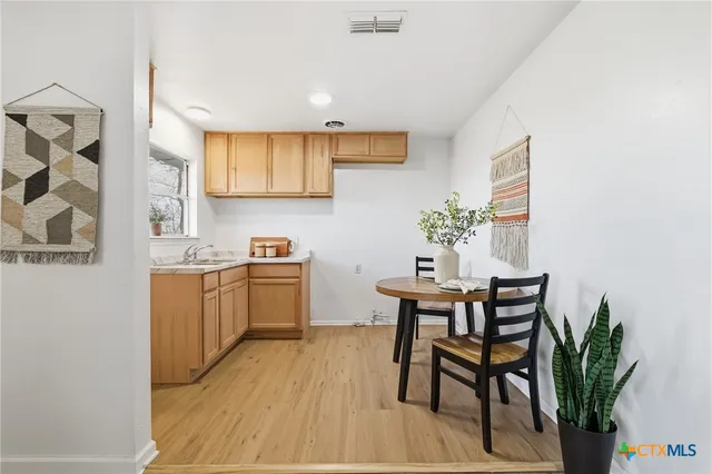 a kitchen with a table and chairs in it
