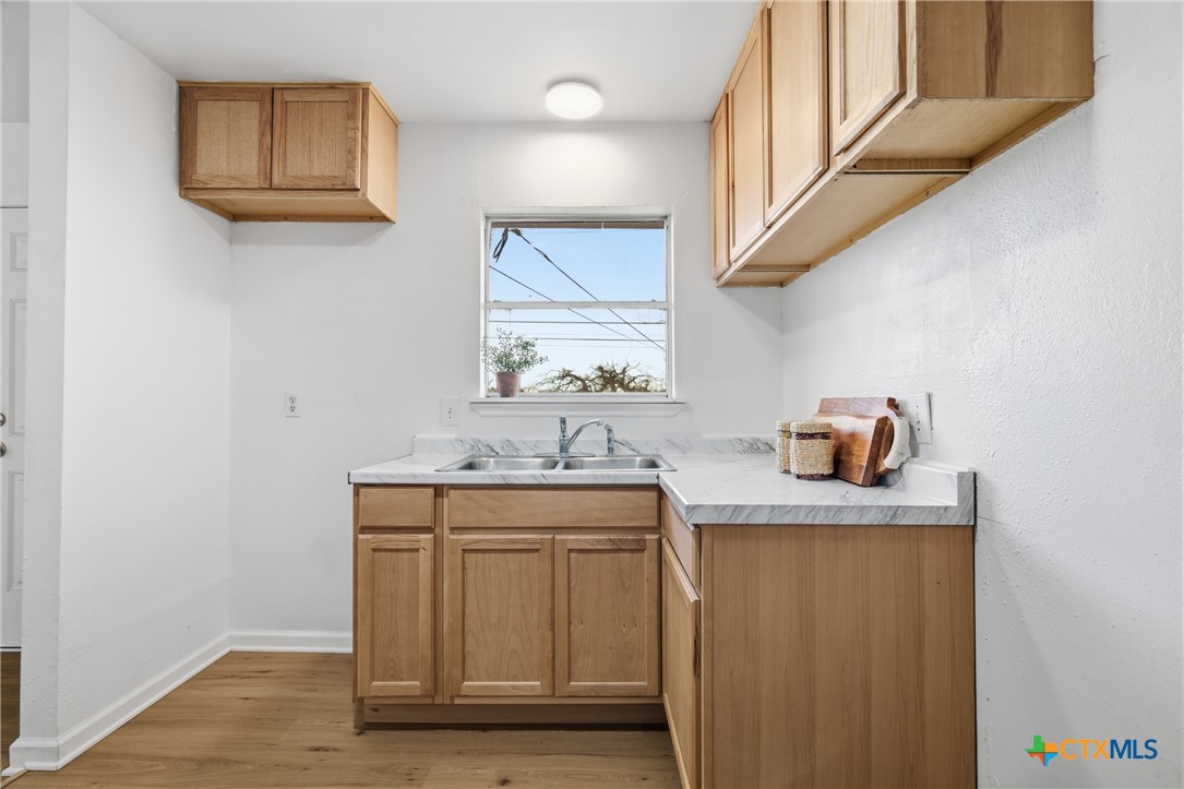 958 Fannin Loop Temple, TX 76501 - Photo 10 of 30 a hallway with sink and mirror