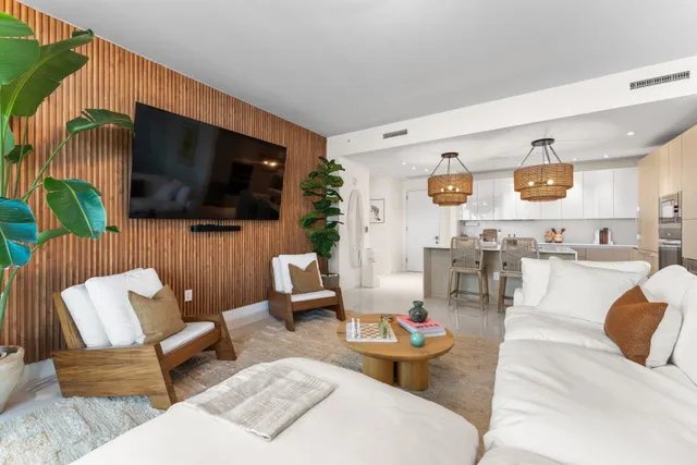 a spacious bedroom with a bed a couch and a potted plant