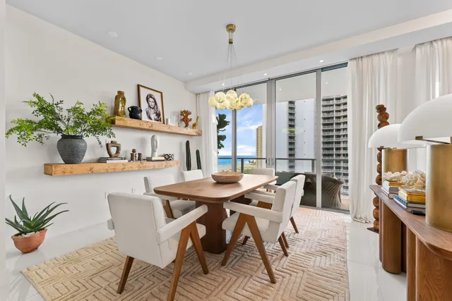 a bedroom with a bed a television and a large window