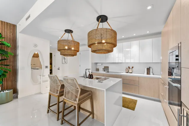 a kitchen with stainless steel appliances granite countertop a sink and a white cabinets