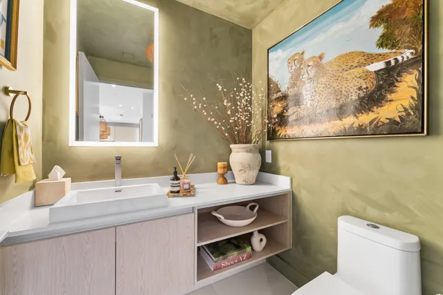 a living room with furniture and a painting on the wall