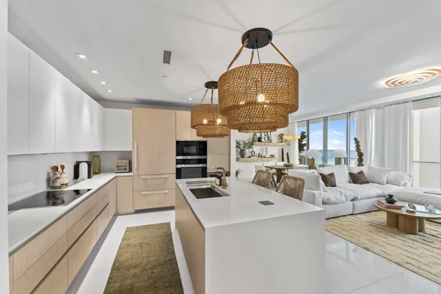 a living room with furniture a chandelier a large window and flat screen tv