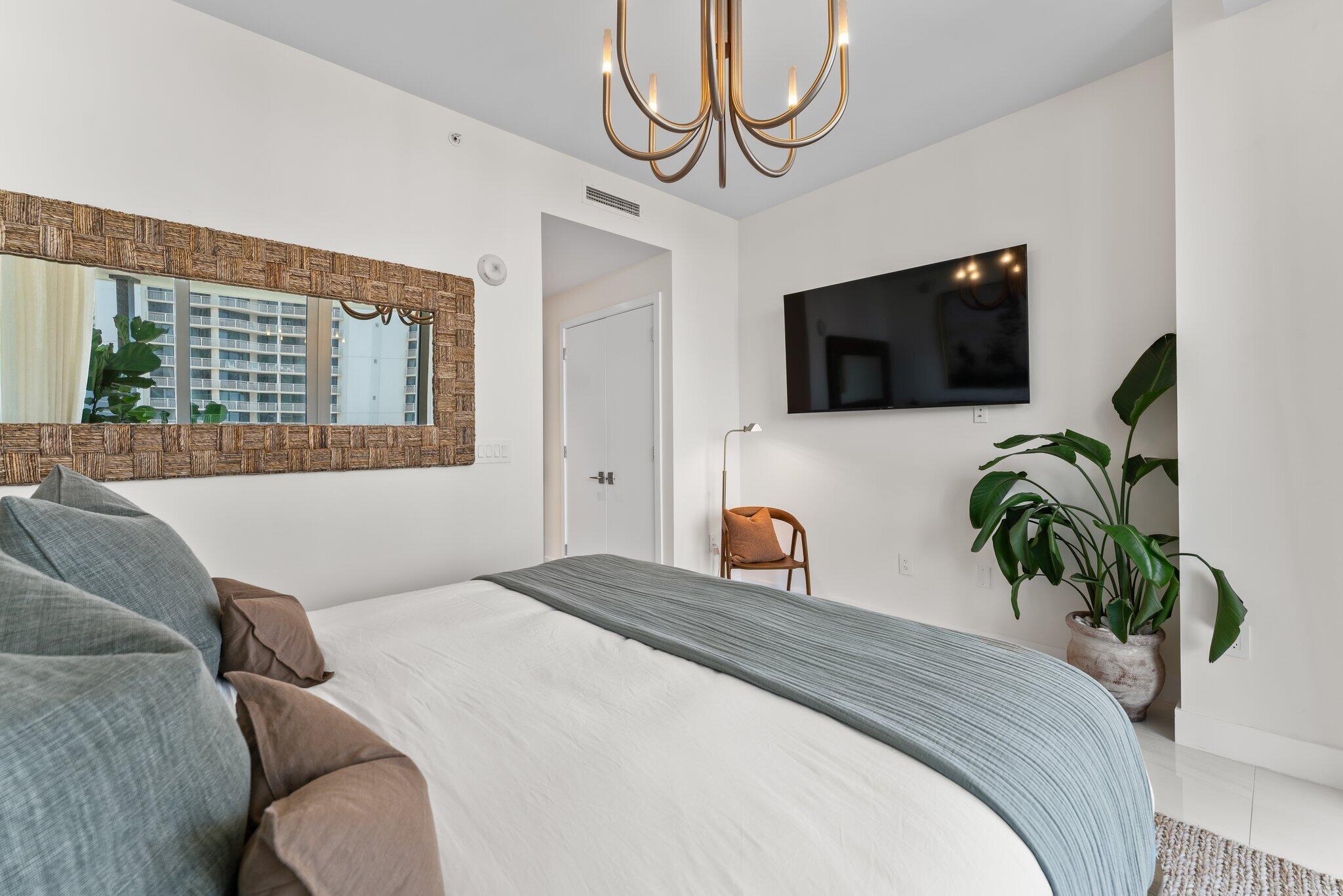 3100 North Ocean Drive, Unit H1006 Singer Island, FL 33404 - Photo 35 of 110 a bedroom with a bed a television and a large window