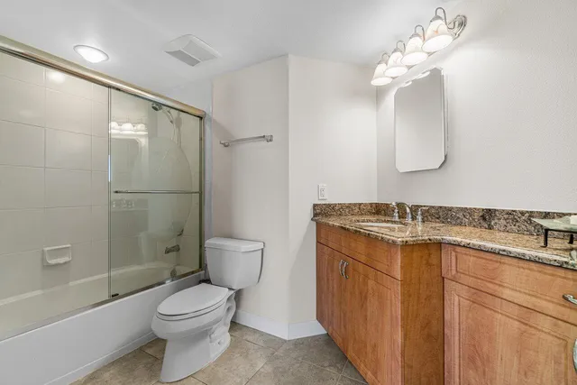 a bathroom with a toilet sink and shower