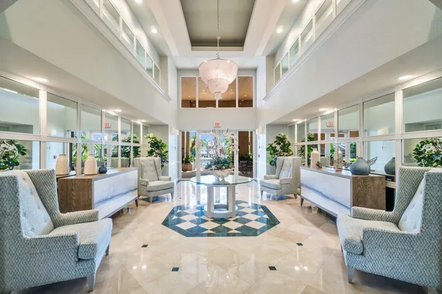 a living room with fireplace furniture and a large window