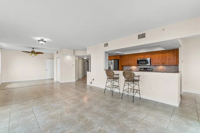 a view of kitchen with furniture and a refrigerator