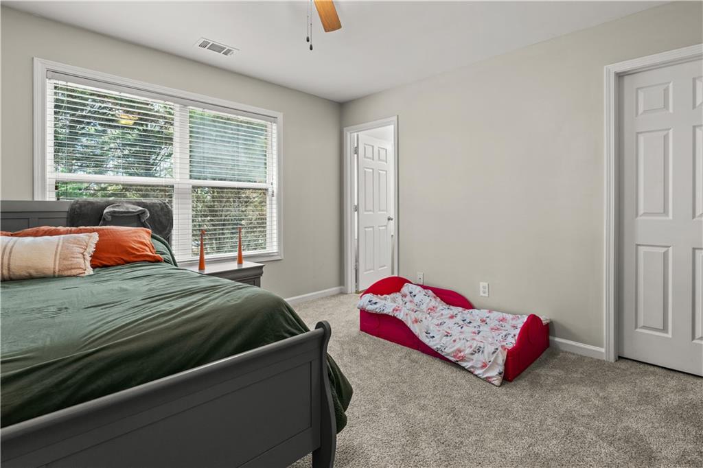 141 Mill Pond Crossing, Unit L3 Carrollton, GA 30116 - Photo 14 of 21 a bedroom with a bed and next to a window