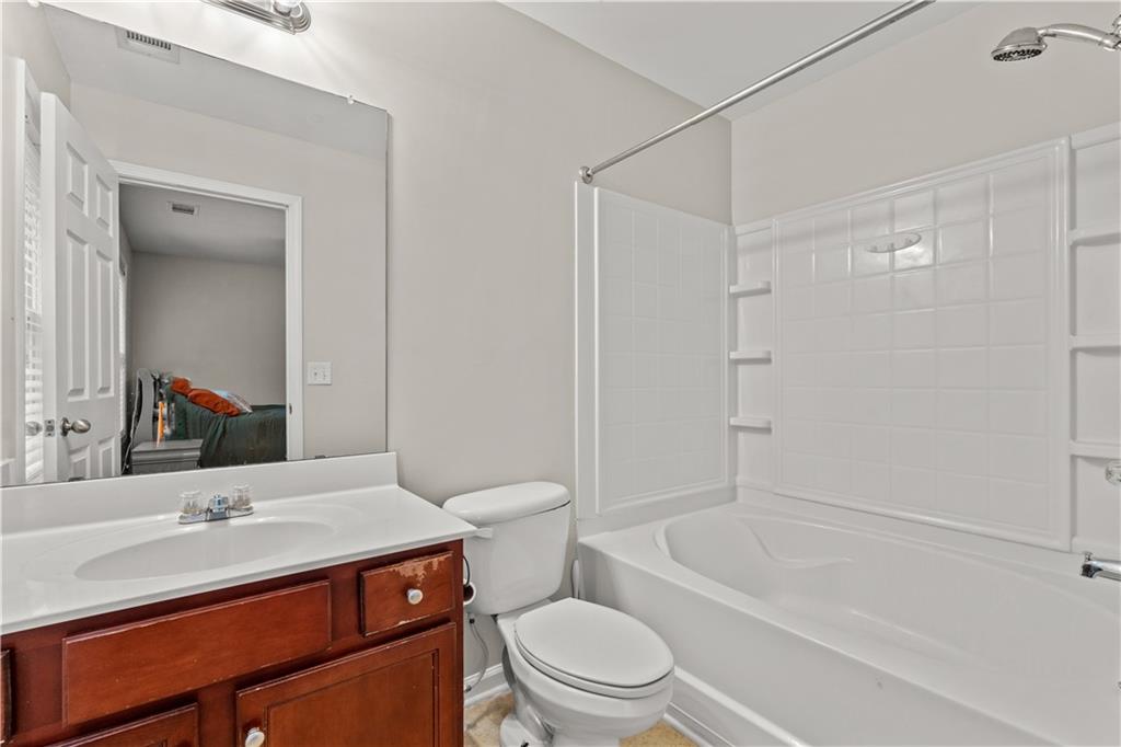 141 Mill Pond Crossing, Unit L3 Carrollton, GA 30116 - Photo 15 of 21 a bathroom with a sink toilet vanity and shower