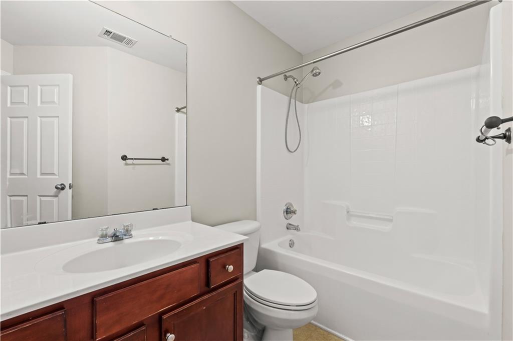141 Mill Pond Crossing, Unit L3 Carrollton, GA 30116 - Photo 19 of 21 a bathroom with a sink a toilet and shower