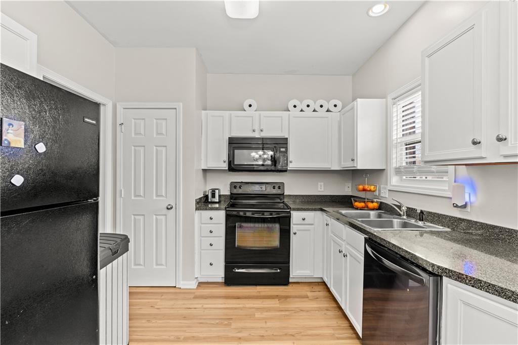 141 Mill Pond Crossing, Unit L3 Carrollton, GA 30116 - Photo 5 of 21 a kitchen with stainless steel appliances granite countertop a stove and a refrigerator
