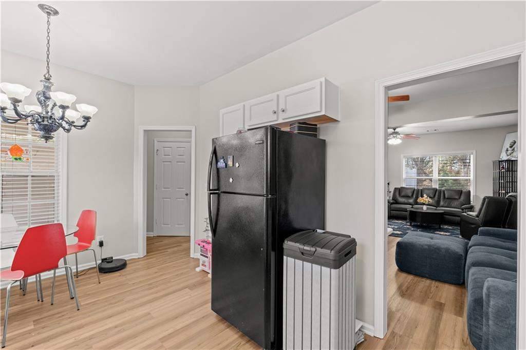 141 Mill Pond Crossing, Unit L3 Carrollton, GA 30116 - Photo 6 of 21 a kitchen with stainless steel appliances granite countertop a refrigerator and a couch