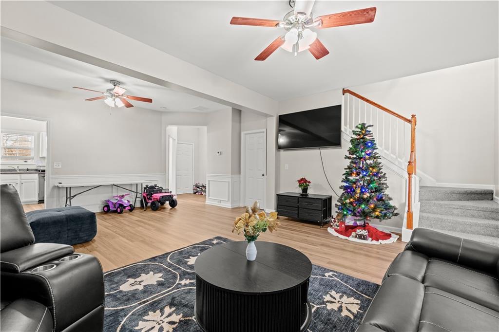 141 Mill Pond Crossing, Unit L3 Carrollton, GA 30116 - Photo 7 of 21 a living room with furniture and a flat screen tv