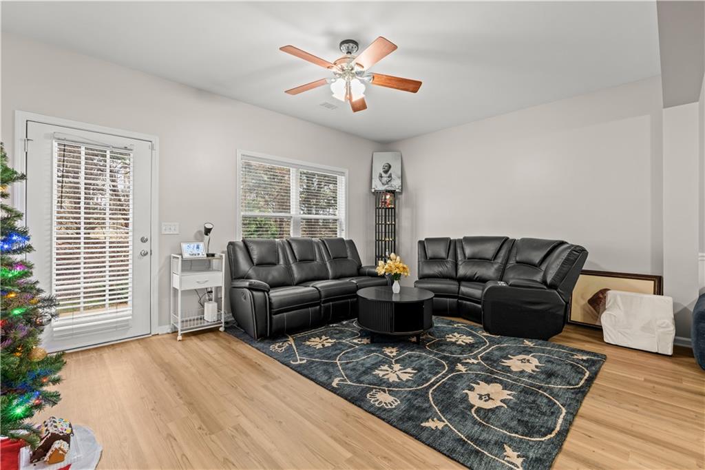 141 Mill Pond Crossing, Unit L3 Carrollton, GA 30116 - Photo 8 of 21 a living room with furniture and a large window