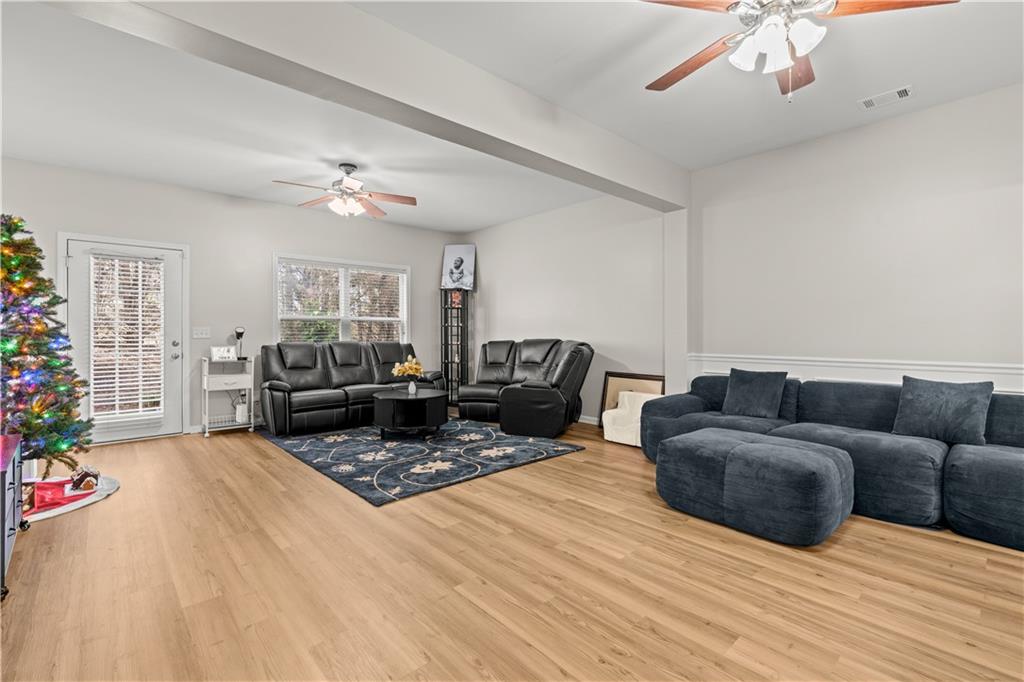 141 Mill Pond Crossing, Unit L3 Carrollton, GA 30116 - Photo 9 of 21 a living room with furniture and a chandelier