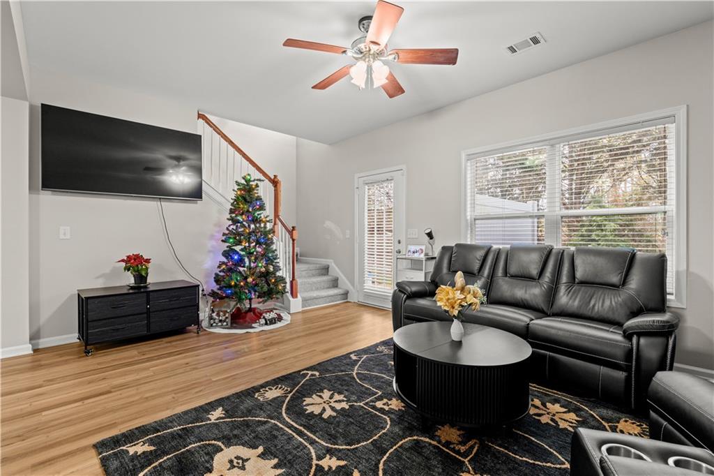 141 Mill Pond Crossing, Unit L3 Carrollton, GA 30116 - Photo 10 of 21 a living room with furniture and a flat screen tv