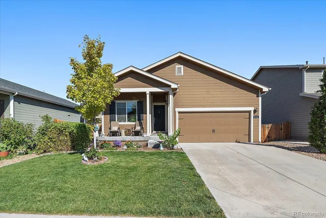 a front view of a house with a garden and porch