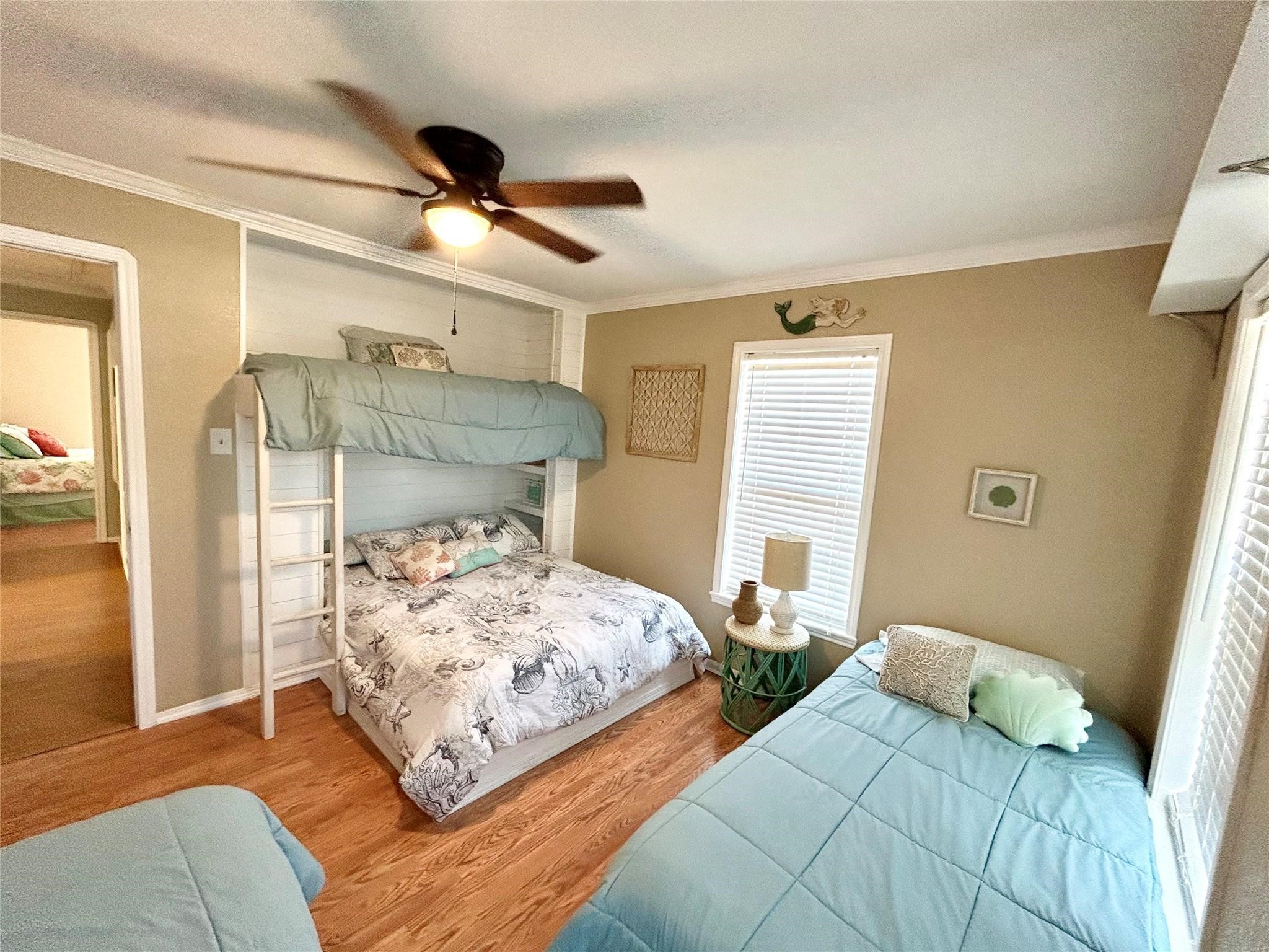 151 Neptune Bay City, TX 77414 - Photo 5 of 26 a bedroom with two beds and painting on the wall
