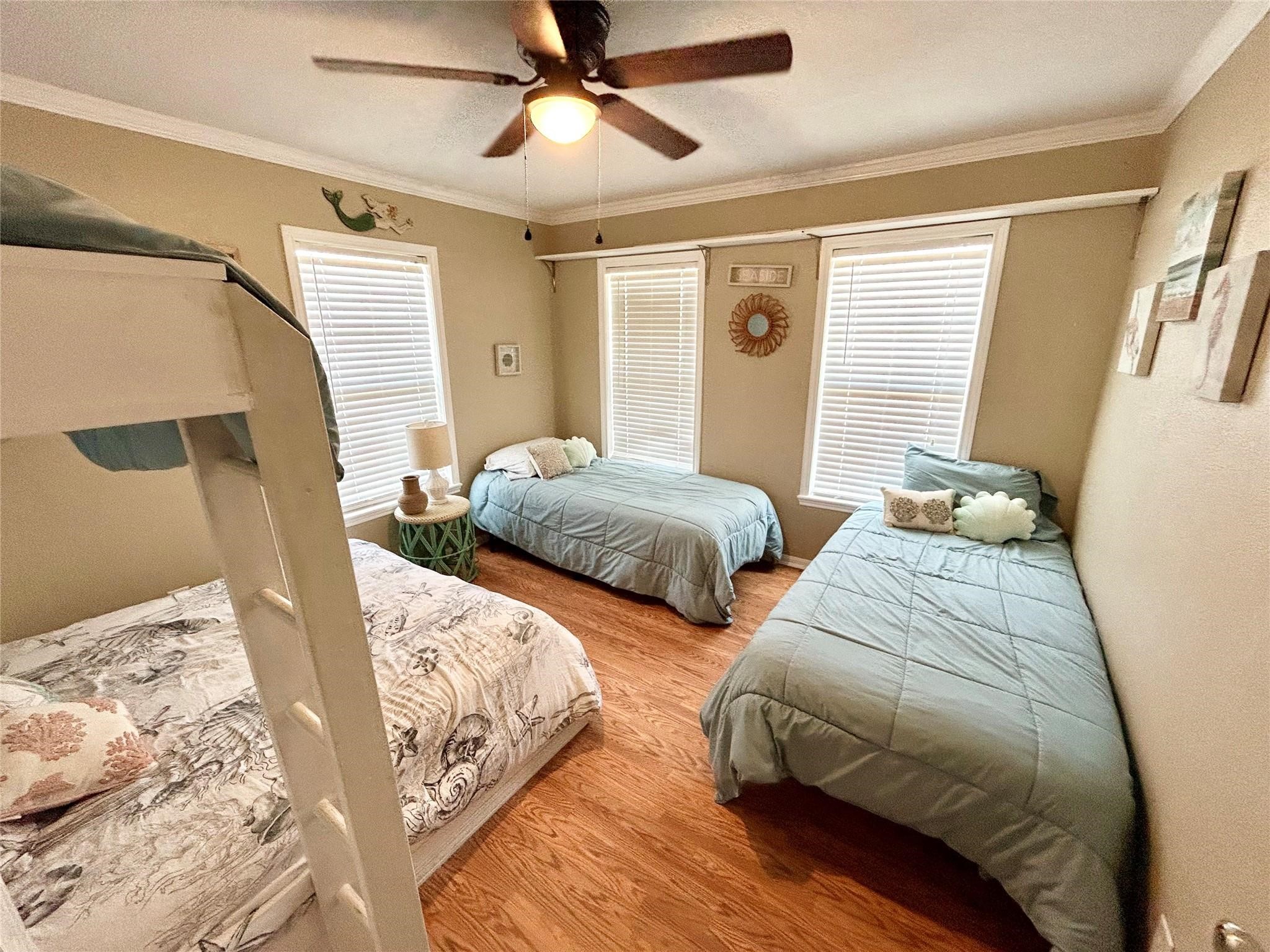 151 Neptune Bay City, TX 77414 - Photo 8 of 26 a bedroom with two beds and a chandelier
