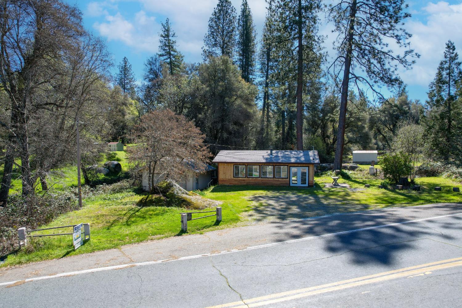 7935 Fairplay Road Somerset, CA 95684 - Photo 20 of 20 a view of a house with a small yard and large trees