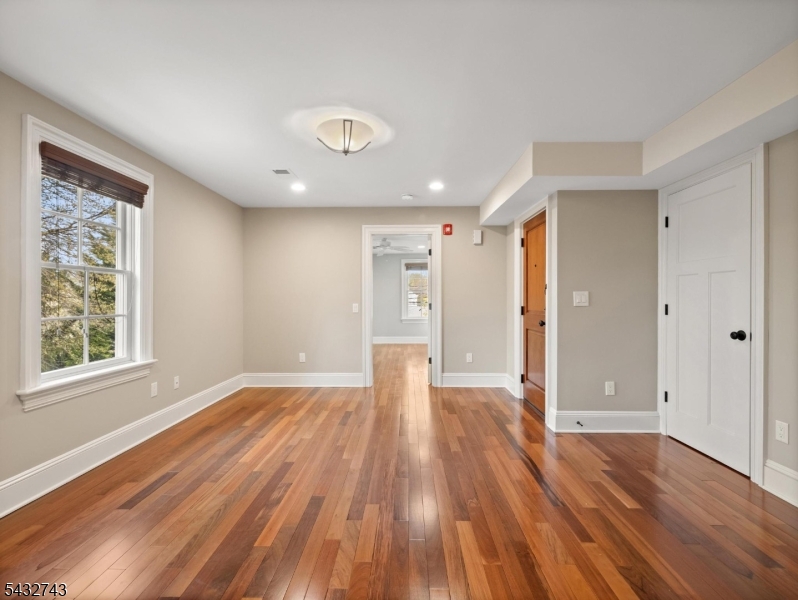 55 Main Street Chatham, NJ 07928 - Photo 2 of 14 an empty room with wooden floor and windows