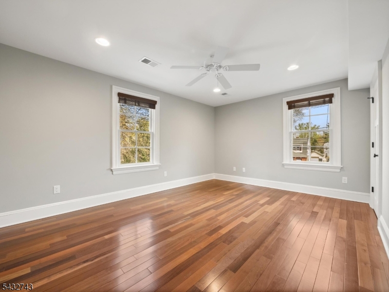 55 Main Street Chatham, NJ 07928 - Photo 3 of 14 a view of an empty room with wooden floor and a window