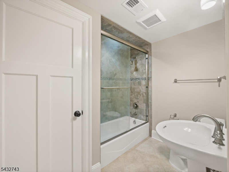 55 Main Street Chatham, NJ 07928 - Photo 5 of 14 a bathroom with a tub shower sink vanity and toilet