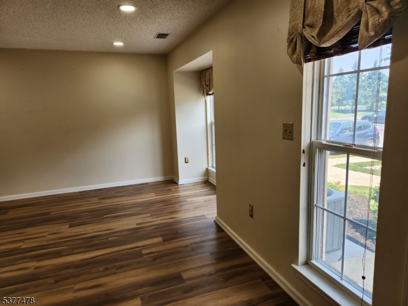 502 Dunn Circle Bridgewater, NJ 08807 - Photo 5 of 23 a view of empty room with wooden floor and fan