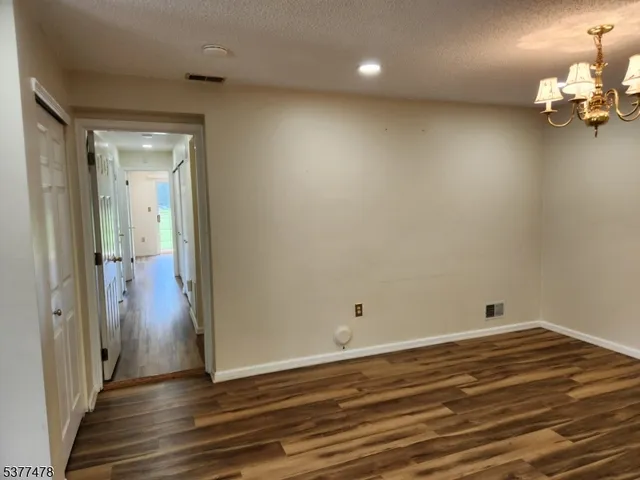 a view of a room with wooden floor