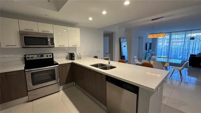 a kitchen that has a sink and a stove in it