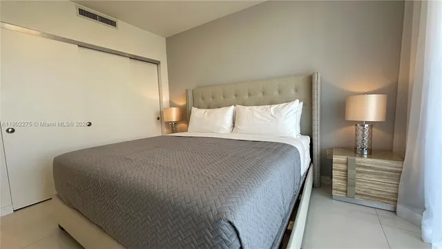 a bedroom with a flat screen tv and a bed