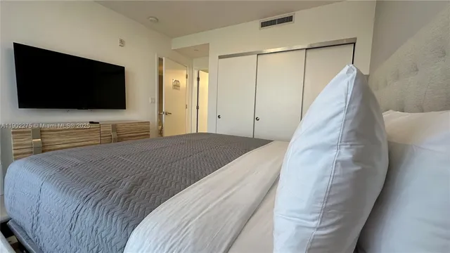 a white toilet sitting next to a bathroom sink