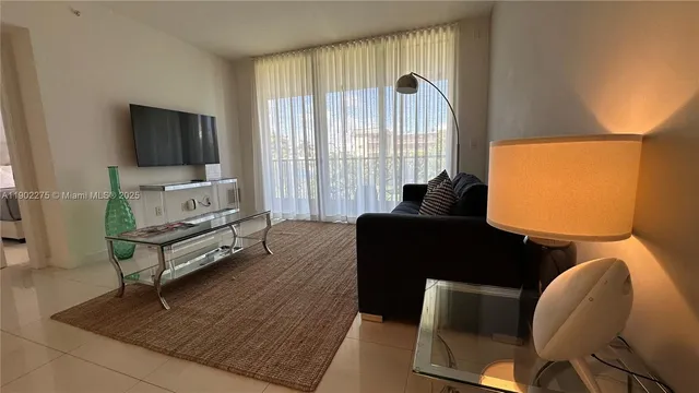 a living room with furniture rug and a flat screen tv