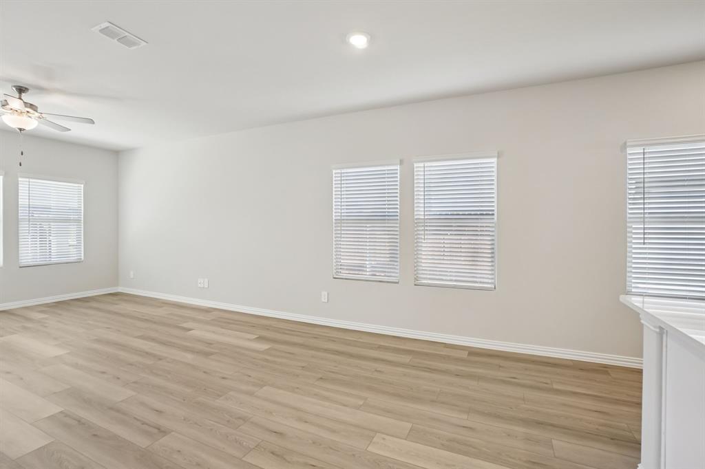 832 Sunflower Road Lavon, TX 75166 - Photo 12 of 39 an empty room with wooden floor and windows