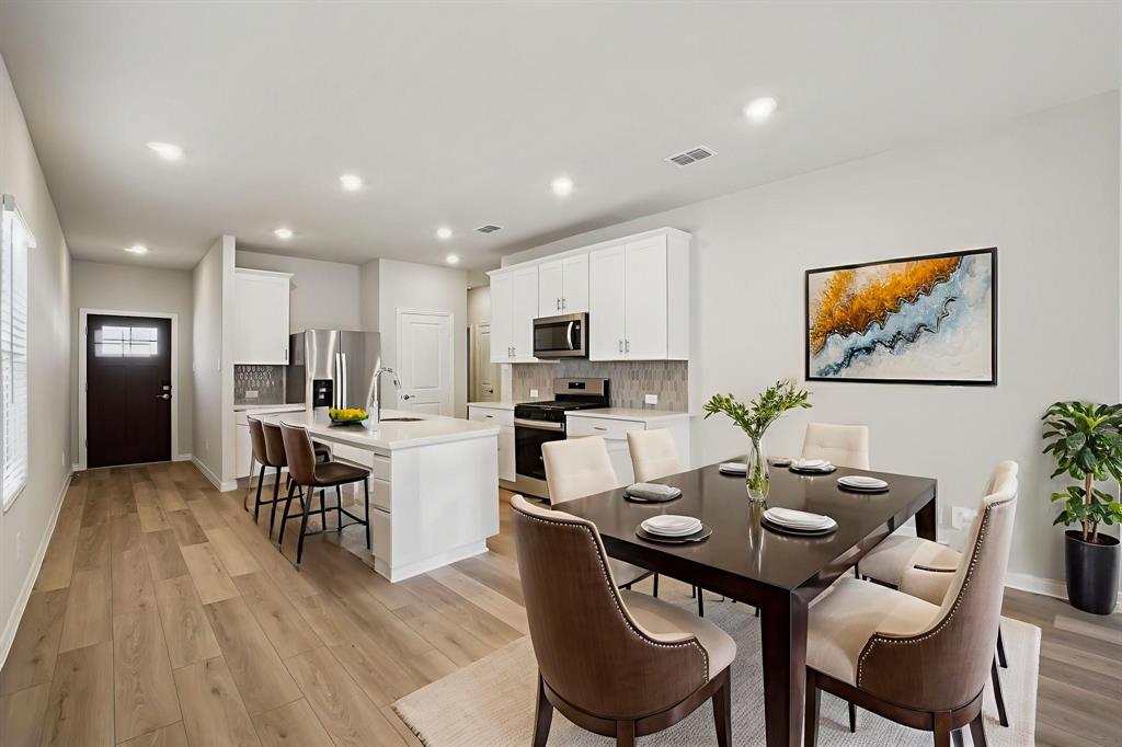 832 Sunflower Road Lavon, TX 75166 - Photo 14 of 39 a view of a dining room with furniture and wooden floor