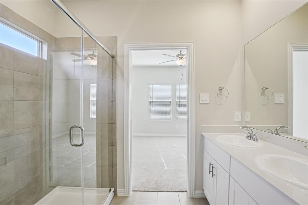 832 Sunflower Road Lavon, TX 75166 - Photo 25 of 39 a bathroom with a shower sink vanity and mirror