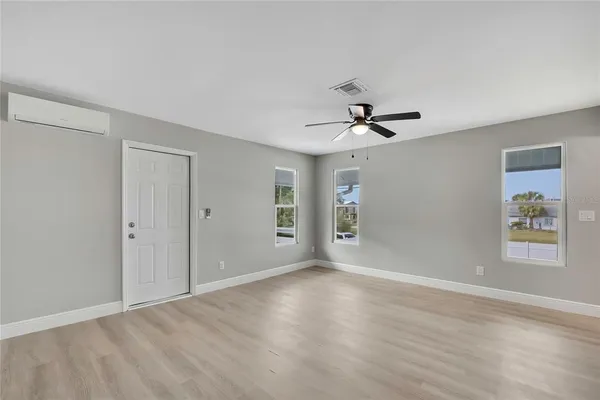 a view of empty room with wooden floor