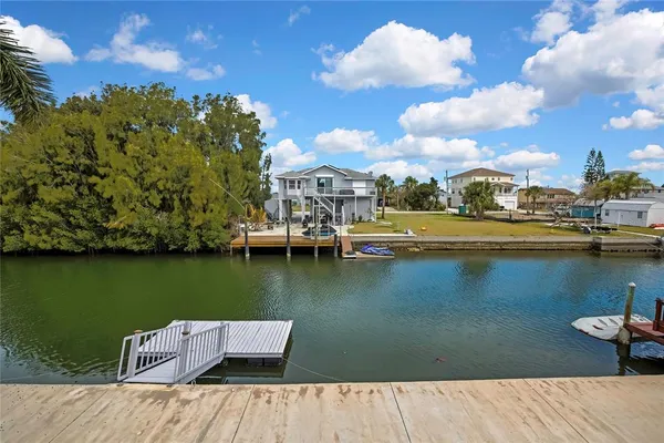 an aerial view of a house with outdoor space lake view and boat