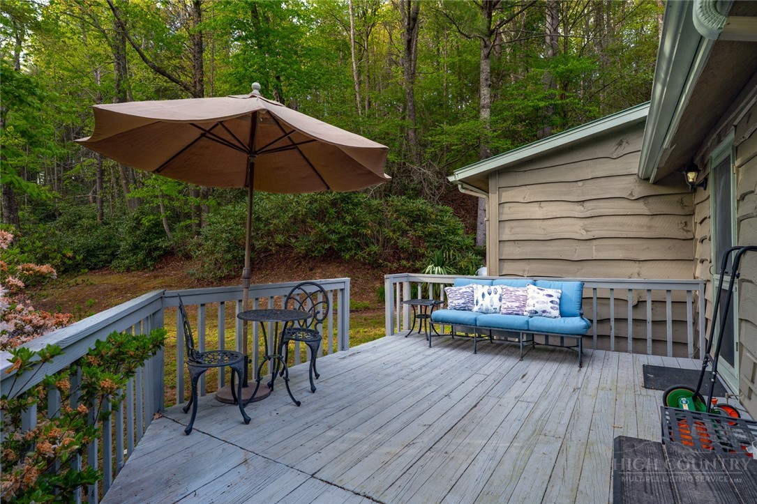 217 Holiday Hills Drive Boone, NC 28607 - Photo 5 of 26 a view of house with deck outdoor seating and wooden floor