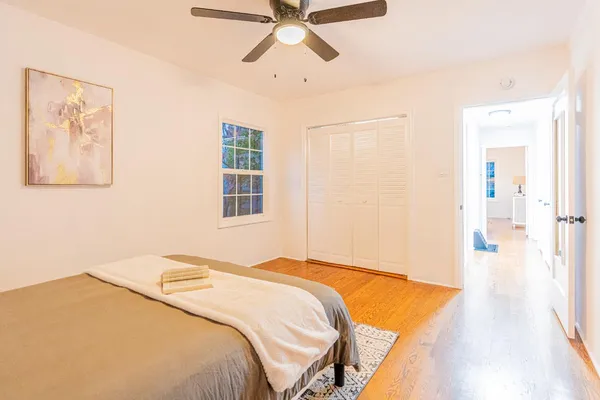 a bedroom with a bed and a painting on the wall