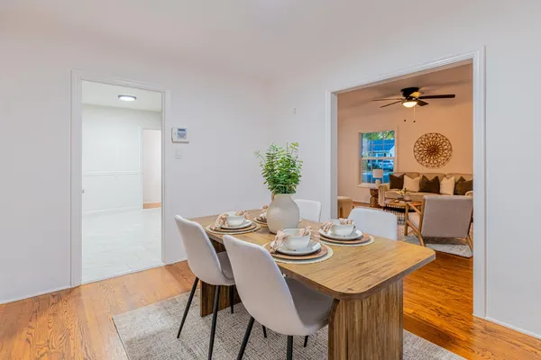 a view of a dining room with furniture and wooden floor