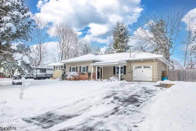 a view of a house with a yard covered in snow
