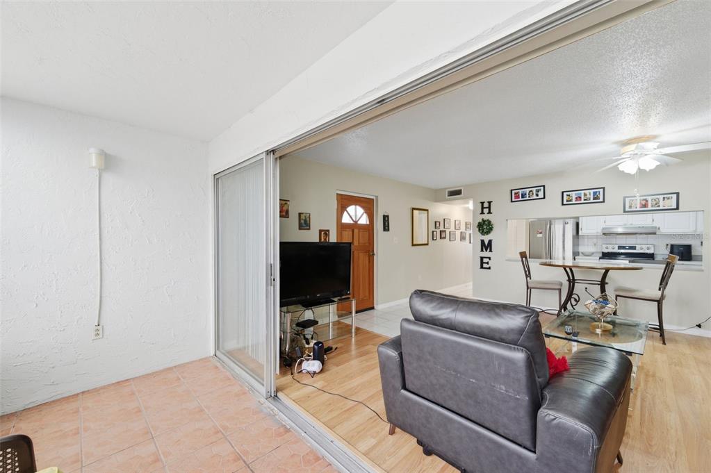 7701 Starkey Road, Unit 237 Seminole, FL 33777 - Photo 11 of 32 a living room with furniture and a flat screen tv