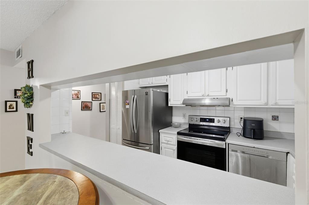 7701 Starkey Road, Unit 237 Seminole, FL 33777 - Photo 14 of 32 a kitchen with stainless steel appliances a refrigerator stove and sink