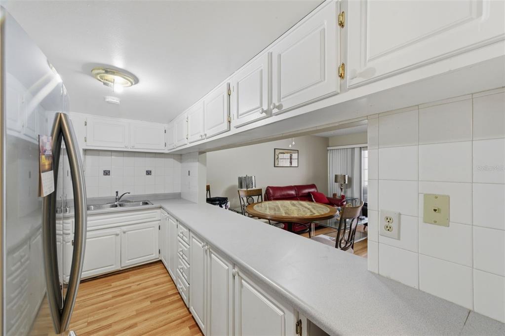7701 Starkey Road, Unit 237 Seminole, FL 33777 - Photo 15 of 32 a kitchen with white cabinets and white appliances