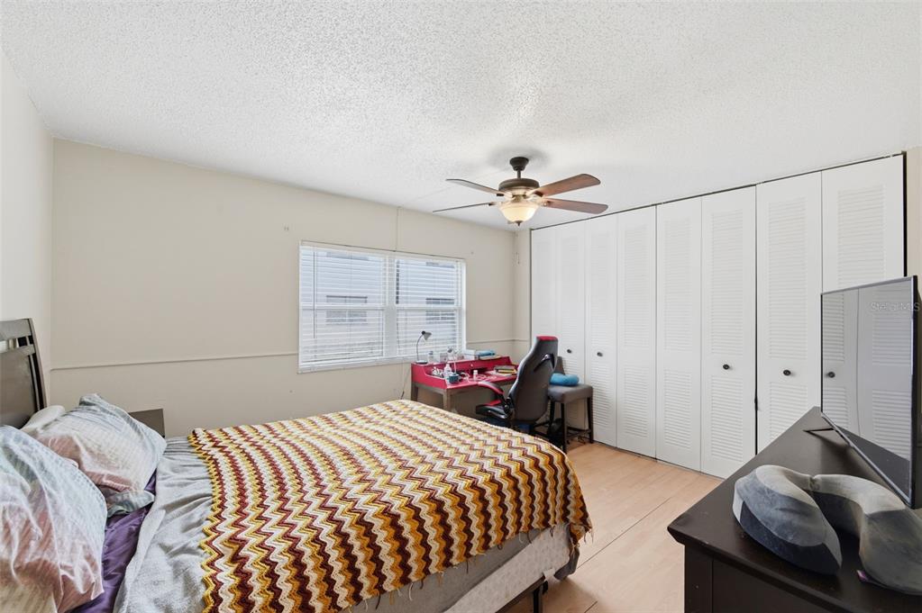 7701 Starkey Road, Unit 237 Seminole, FL 33777 - Photo 18 of 32 a bedroom with a bed and a chandelier